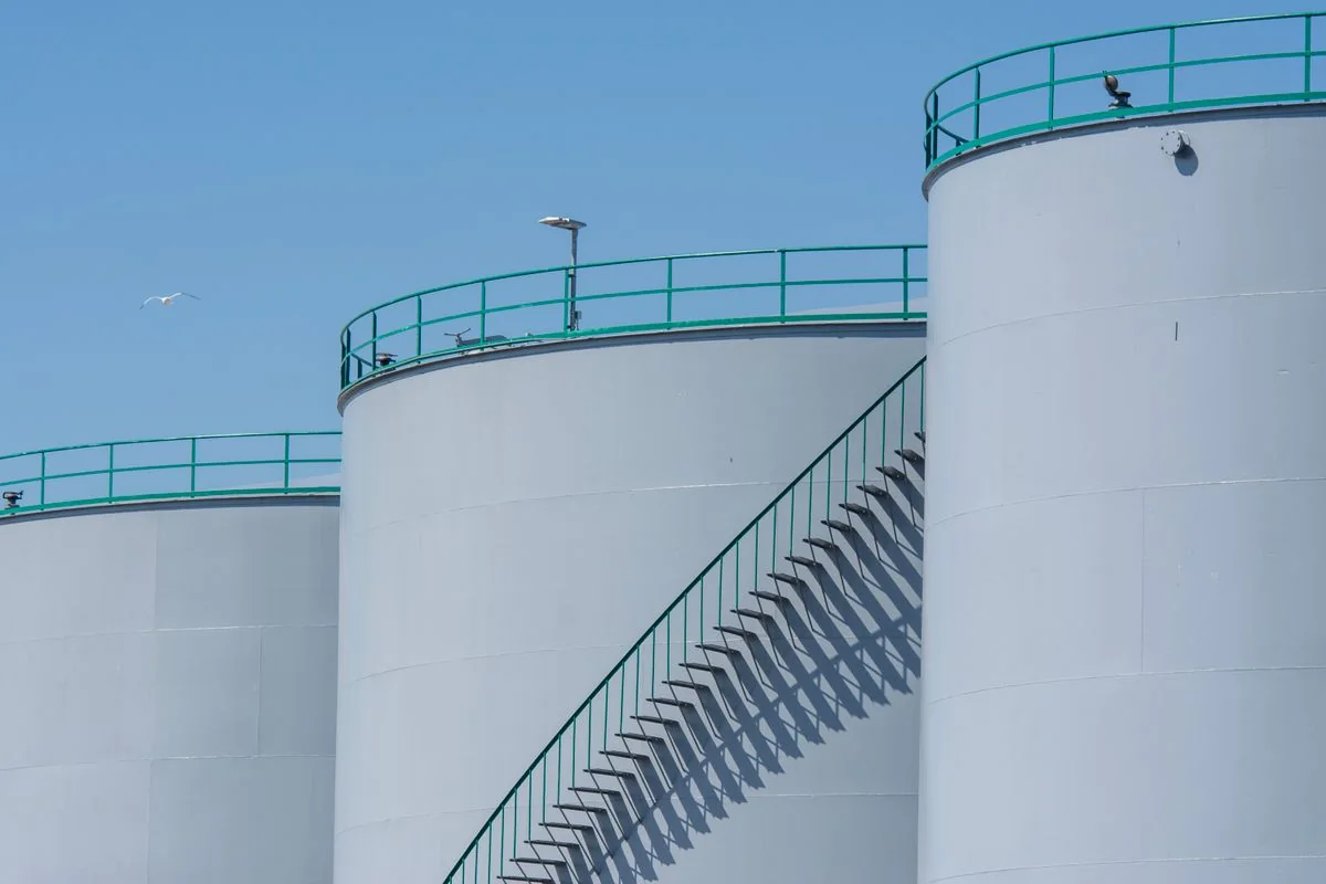 Large industrial liquid-storage tanks with access stairways